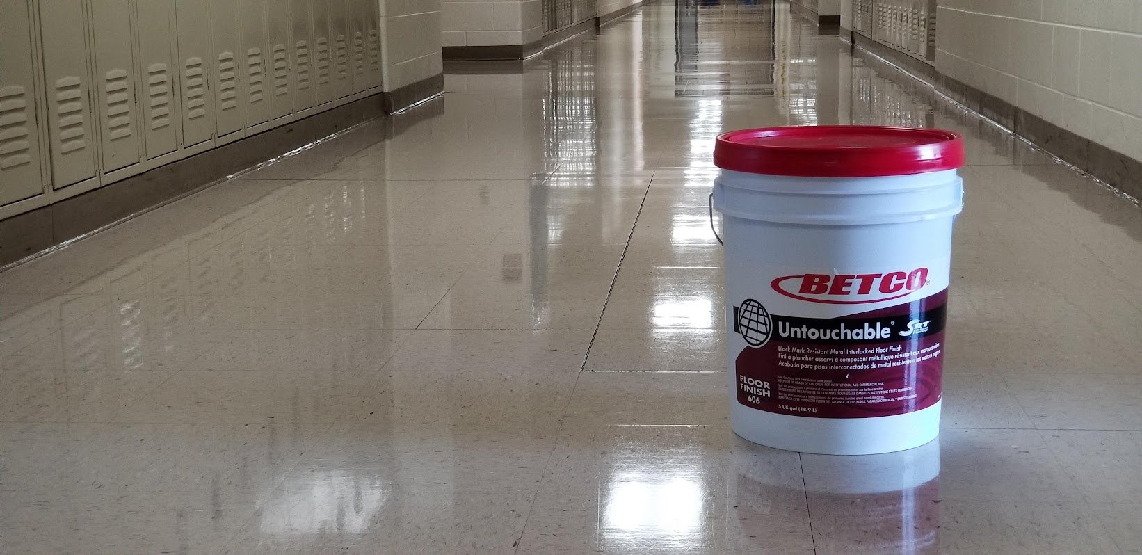 A vinyl floor with a bucket of cleaner on it