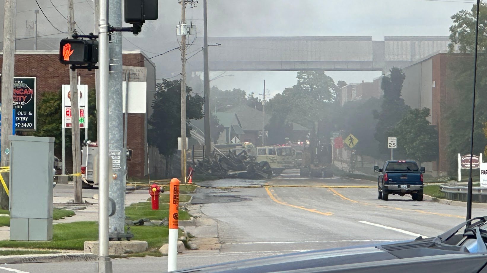 a street blanketed by smoke from a nearby fire