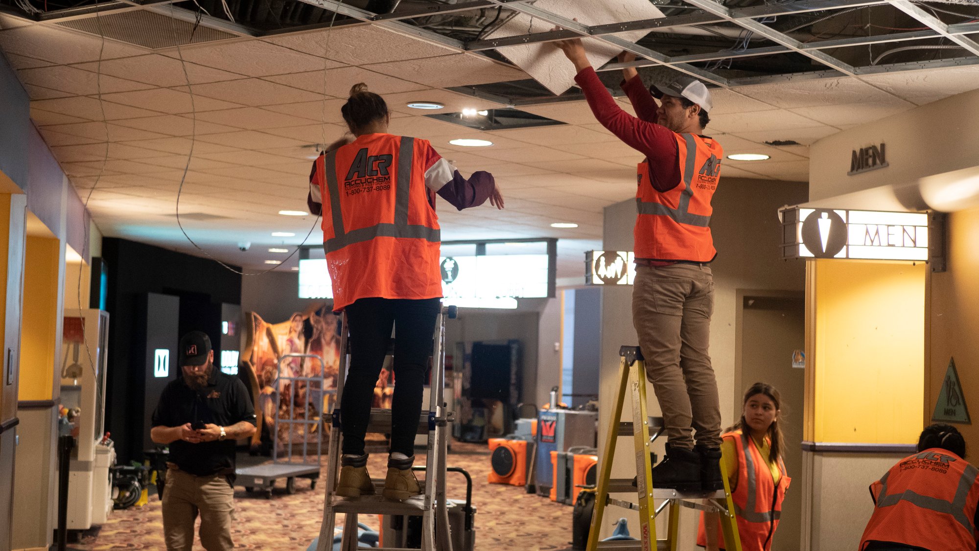Workmen repairing a ceiling